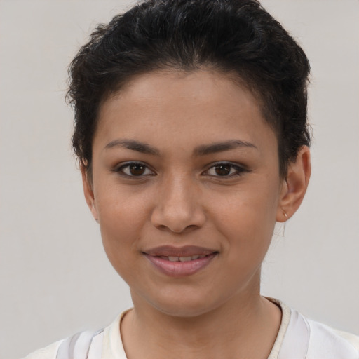 Joyful latino young-adult female with short  brown hair and brown eyes