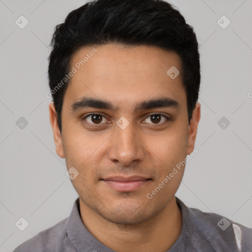 Joyful latino young-adult male with short  black hair and brown eyes