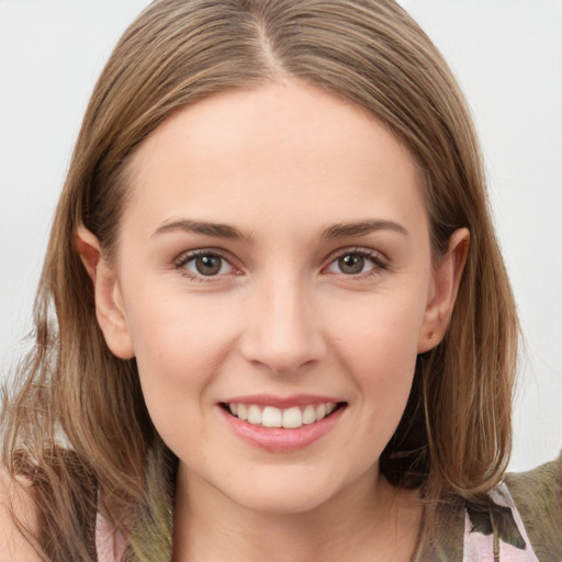 Joyful white young-adult female with long  brown hair and grey eyes