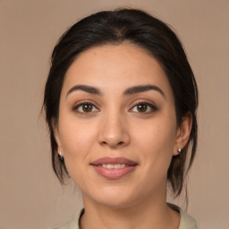 Joyful latino young-adult female with medium  brown hair and brown eyes