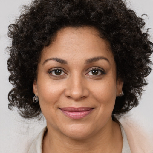 Joyful black young-adult female with medium  brown hair and brown eyes