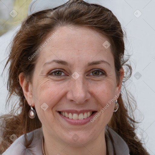 Joyful white adult female with long  brown hair and brown eyes