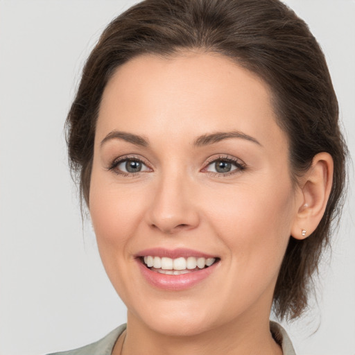 Joyful white young-adult female with medium  brown hair and brown eyes