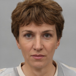 Joyful white adult female with short  brown hair and brown eyes