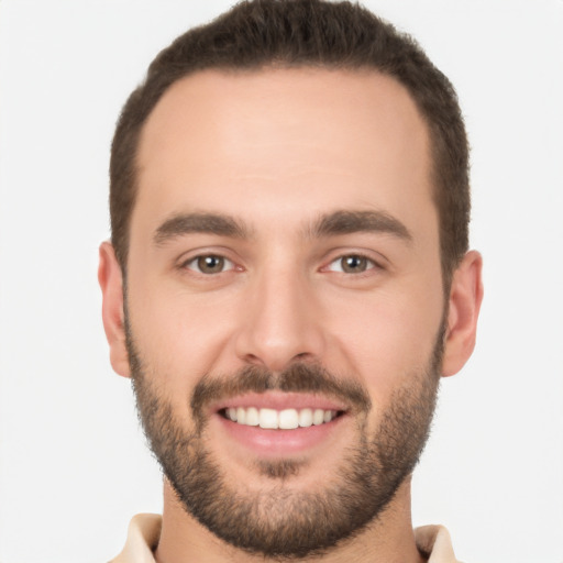 Joyful white young-adult male with short  brown hair and brown eyes