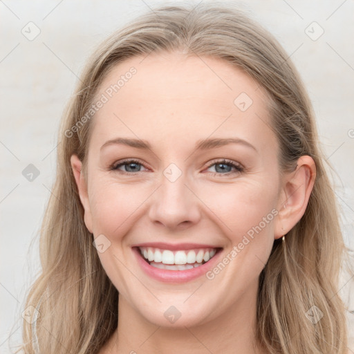 Joyful white young-adult female with long  brown hair and blue eyes