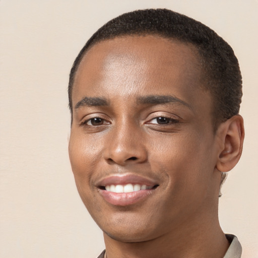 Joyful black young-adult male with short  brown hair and brown eyes