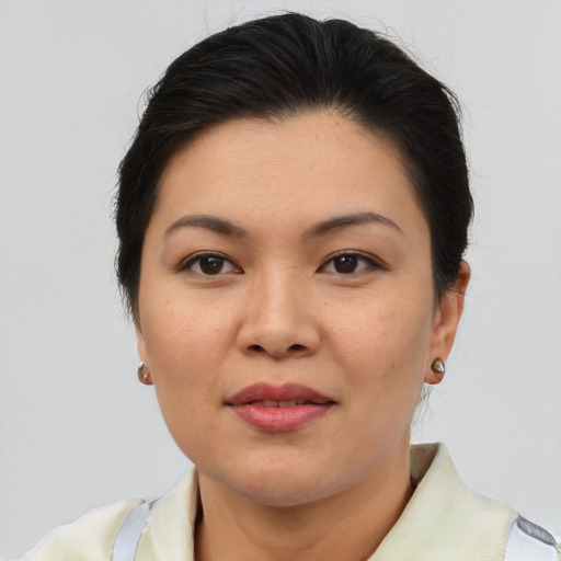 Joyful asian young-adult female with short  brown hair and brown eyes