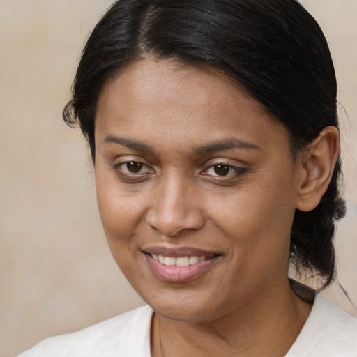 Joyful black young-adult female with medium  brown hair and brown eyes