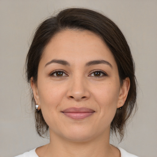 Joyful white young-adult female with medium  brown hair and brown eyes