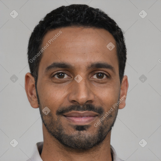 Joyful black young-adult male with short  black hair and brown eyes