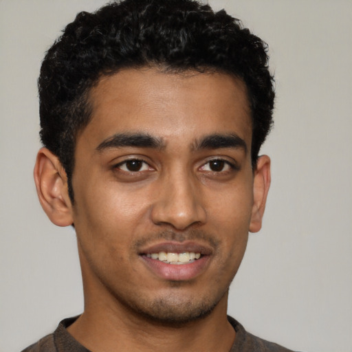 Joyful latino young-adult male with short  brown hair and brown eyes