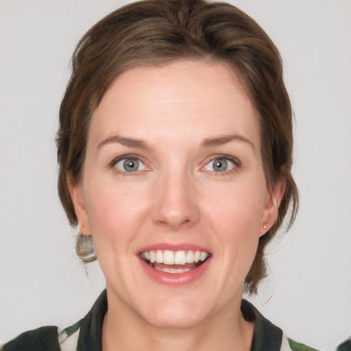 Joyful white young-adult female with medium  brown hair and green eyes