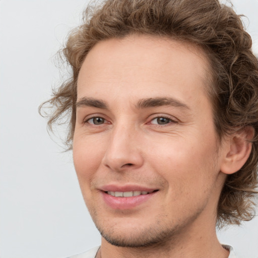 Joyful white young-adult male with medium  brown hair and brown eyes