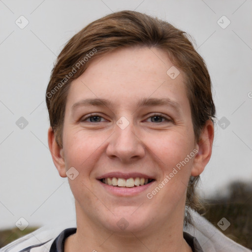 Joyful white young-adult female with short  brown hair and grey eyes