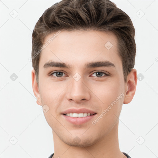 Joyful white young-adult male with short  brown hair and grey eyes