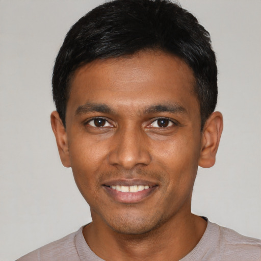 Joyful black young-adult male with short  black hair and brown eyes