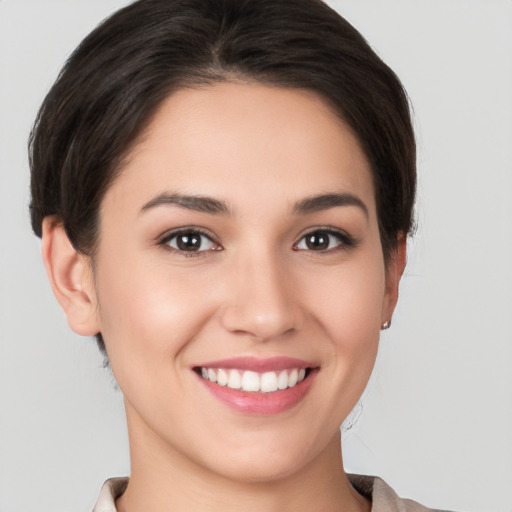 Joyful white young-adult female with short  brown hair and brown eyes