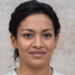 Joyful latino young-adult female with short  brown hair and brown eyes