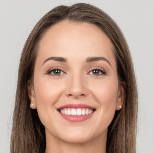 Joyful white young-adult female with long  brown hair and grey eyes