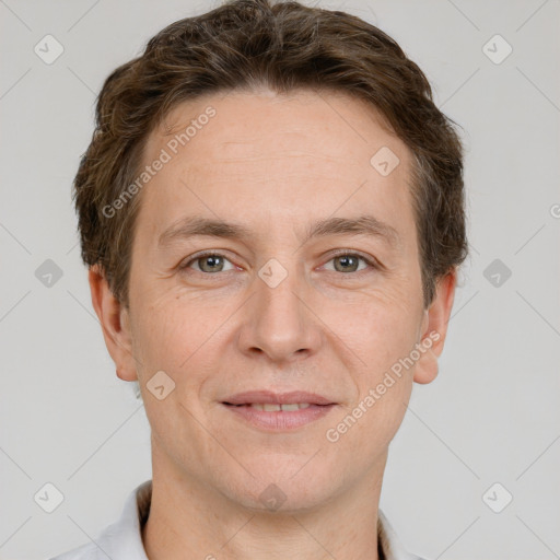 Joyful white adult male with short  brown hair and grey eyes