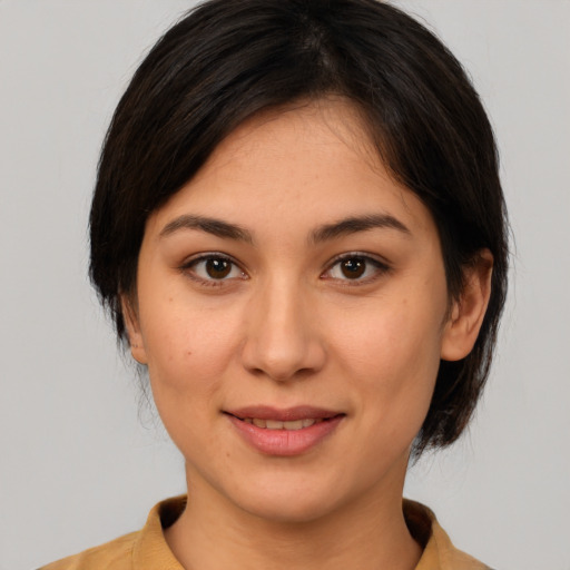 Joyful latino young-adult female with medium  brown hair and brown eyes