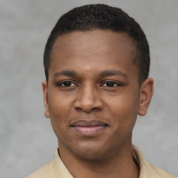 Joyful latino young-adult male with short  brown hair and brown eyes