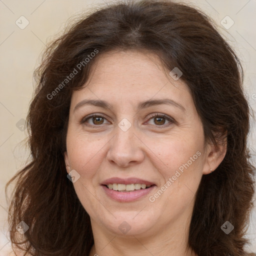 Joyful white adult female with long  brown hair and brown eyes