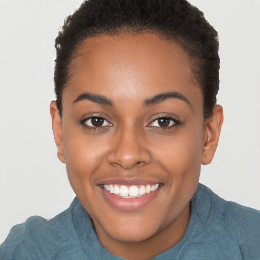 Joyful black young-adult female with short  brown hair and brown eyes