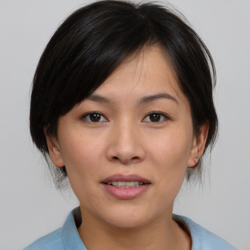 Joyful asian young-adult female with medium  brown hair and brown eyes