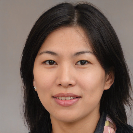 Joyful asian young-adult female with medium  brown hair and brown eyes