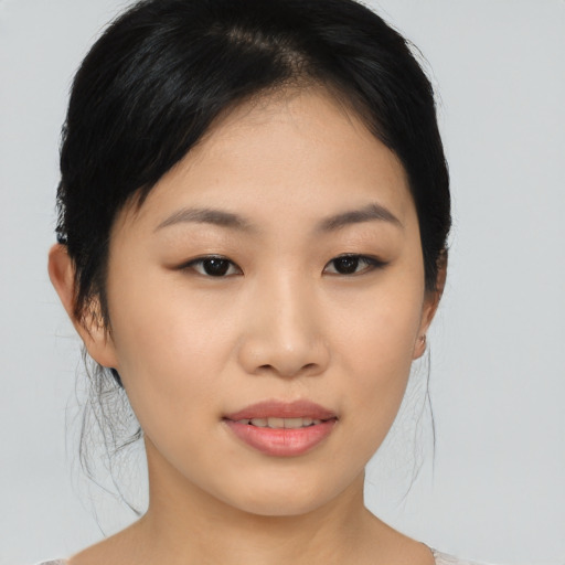 Joyful asian young-adult female with medium  black hair and brown eyes