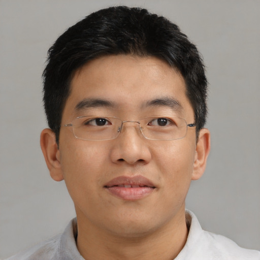 Joyful asian adult male with short  brown hair and brown eyes