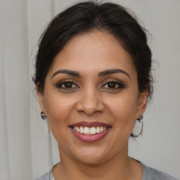 Joyful white young-adult female with medium  brown hair and brown eyes