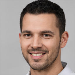 Joyful white young-adult male with short  brown hair and brown eyes