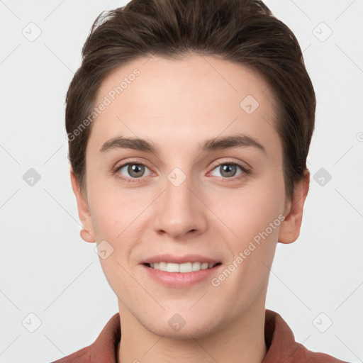 Joyful white young-adult female with short  brown hair and grey eyes