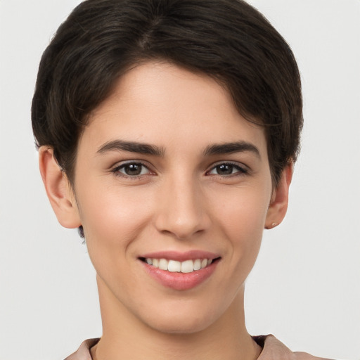 Joyful white young-adult female with short  brown hair and brown eyes