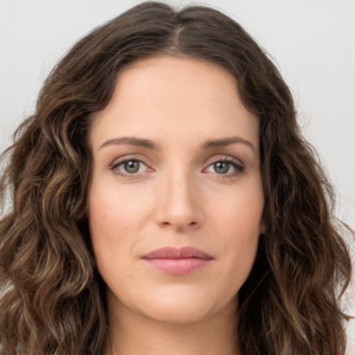 Joyful white young-adult female with long  brown hair and green eyes