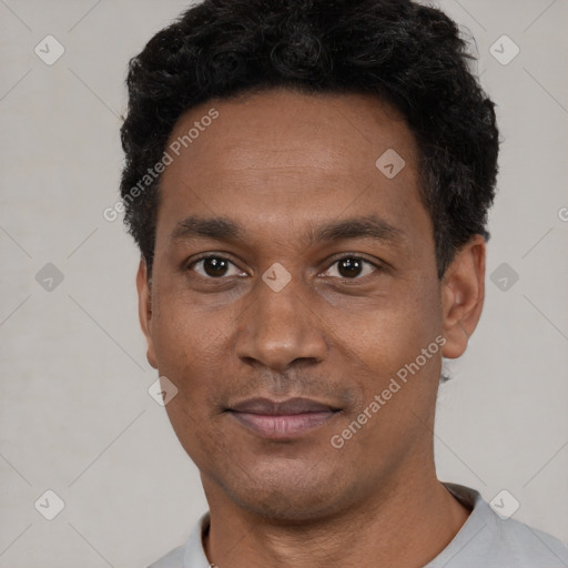 Joyful black adult male with short  black hair and brown eyes