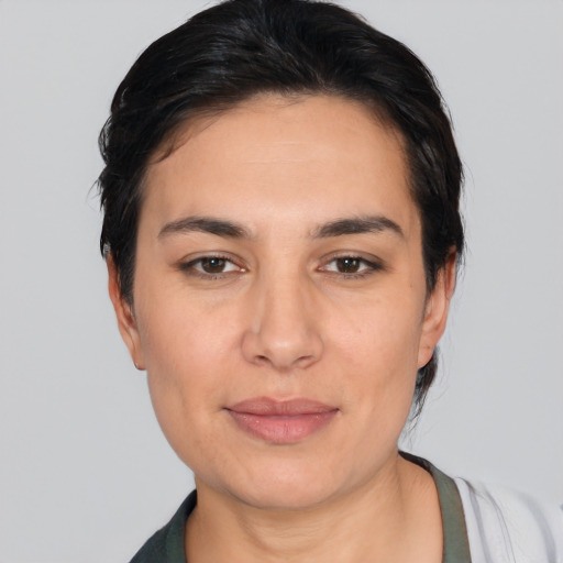 Joyful white young-adult female with medium  black hair and brown eyes