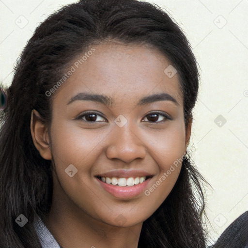 Joyful black young-adult female with long  brown hair and brown eyes