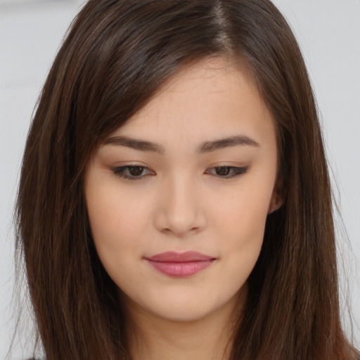 Joyful asian young-adult female with long  brown hair and brown eyes