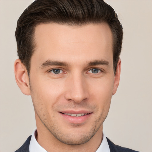 Joyful white young-adult male with short  brown hair and brown eyes