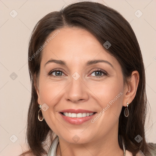 Joyful white adult female with medium  brown hair and brown eyes