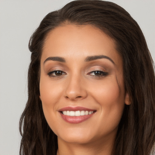 Joyful white young-adult female with long  brown hair and brown eyes