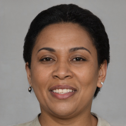 Joyful latino adult female with short  brown hair and brown eyes