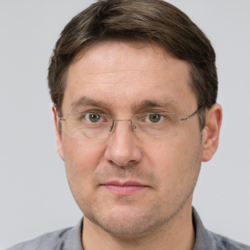 Joyful white adult male with short  brown hair and grey eyes