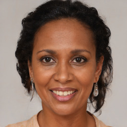 Joyful black adult female with medium  brown hair and brown eyes