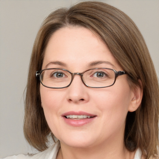 Joyful white adult female with medium  brown hair and blue eyes