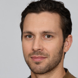 Joyful white adult male with short  brown hair and brown eyes